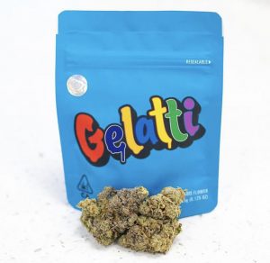 Dense, trichome-frosted buds of the premium Gelati strain showing deep purple and forest green hues from Top THC Shop.