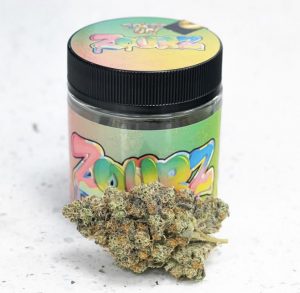 Frosty, trichome-coated buds of the exotic Zours strain showcasing bright orange hairs from Top THC Shop.