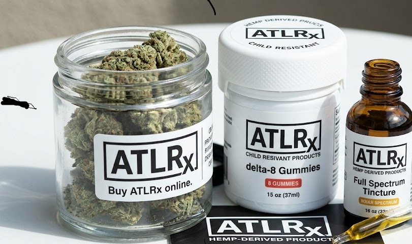A collection of premium hemp items including flower in a clear jar, a tincture bottle, and an oil dropper displaying a clear Buy ATLRx online layout.
