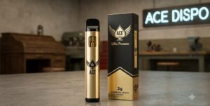A premium metallic gold Ace Ultra Premium 2g disposable vape pen resting inside an orange presentation box with a matching cloth storage bag.